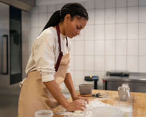 medium-shot-woman-baking-kitchen 1